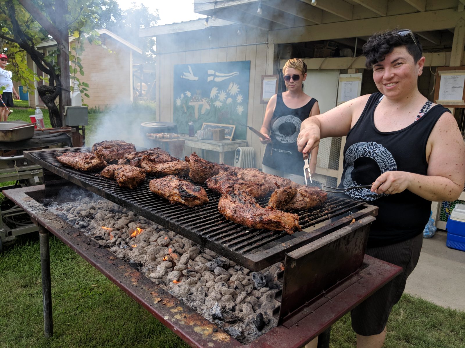 Tri-tip and chicken sizzling over the coals at the communal grill