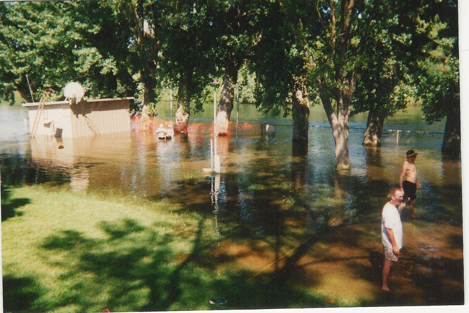 Campers wading through the flooded campground in a high-water year