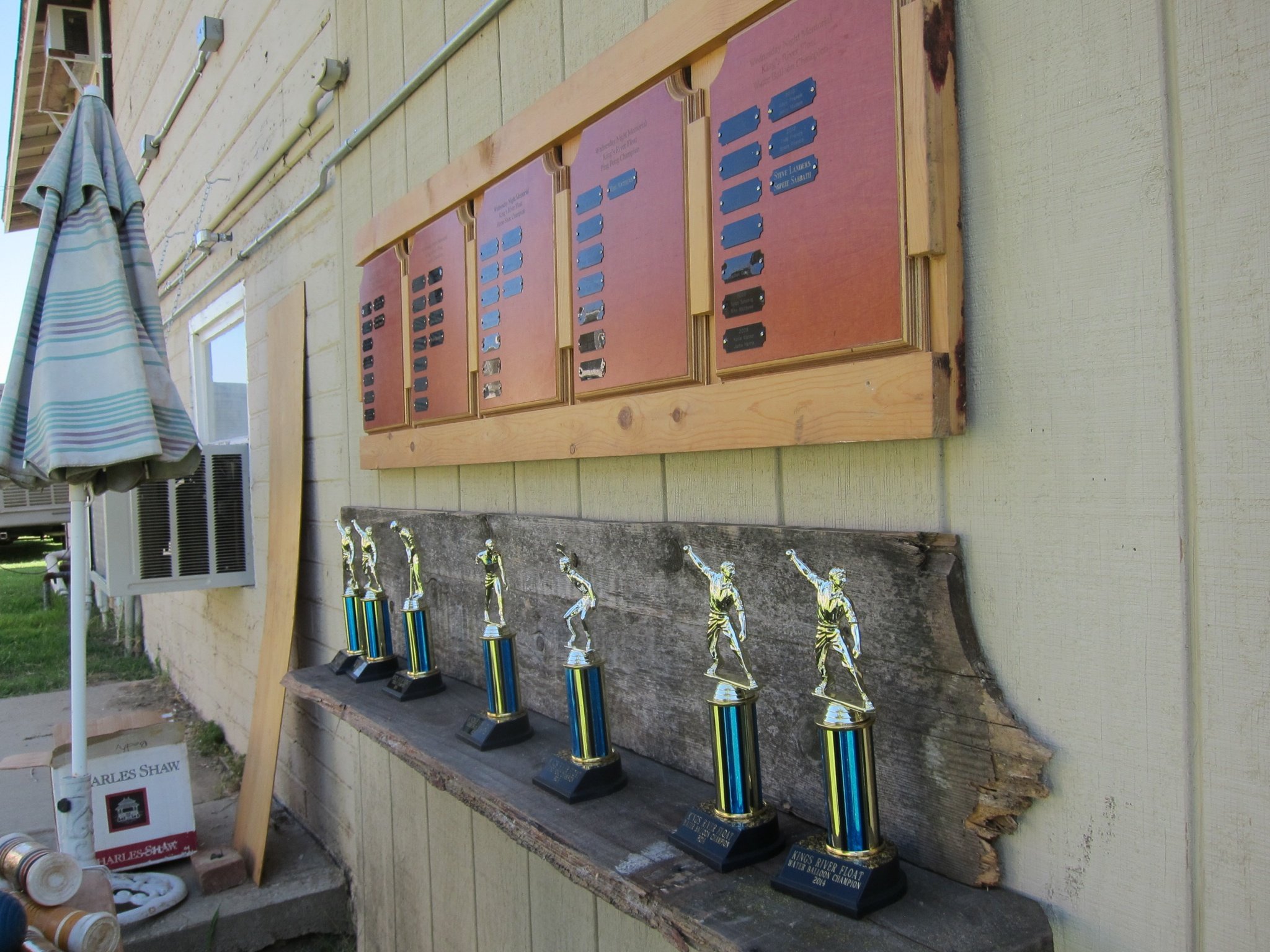 The wall of float-tournament trophies and champion plaques